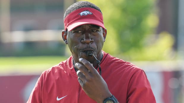 Razorbacks running backs coach Jimmy Smith during Friday morning's practice on the outdoor fields